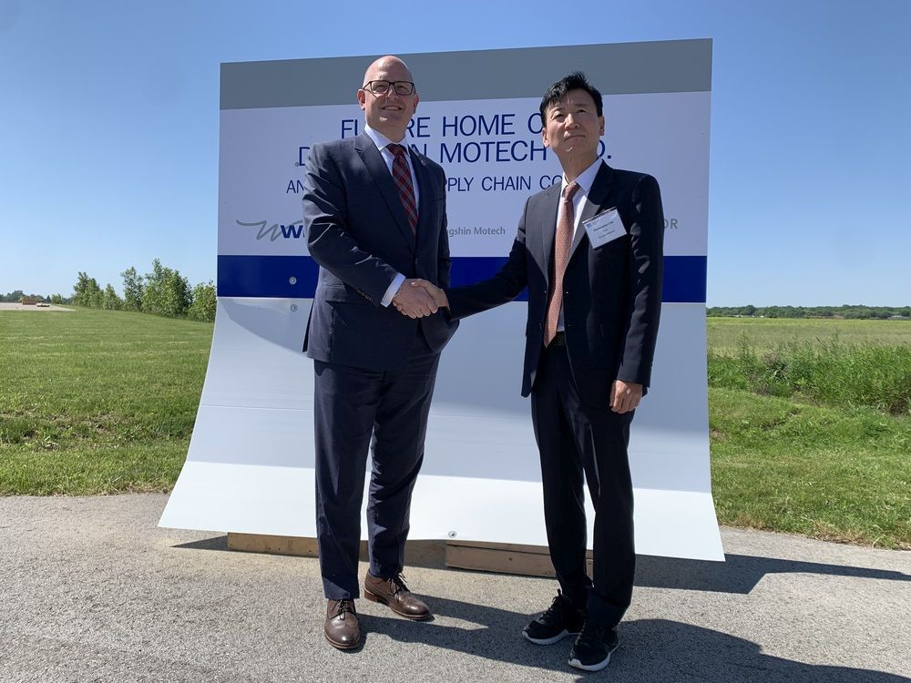 Windsor Mayor Drew Dilkens and DongShin Motech CEO Choon Woo Lim shake hands on Friday, June 3, 2022, at a news conference held to announce a multimillion-dollar investment in Windsor by the South Korean company.